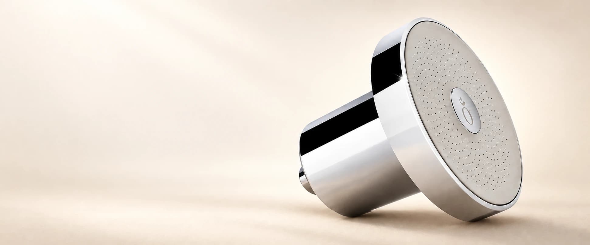 Feels Like Om chrome shower head on a warm cream studio background